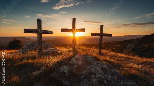 Photographie three wooden chrsitian crucifix crosses on hill at sunset