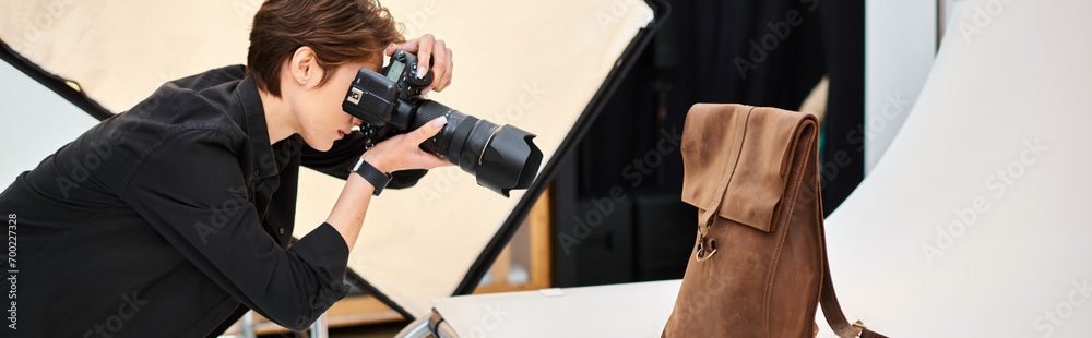 pretty female photographer taking photos of brown leathered backpack in her studio, banner - obrazy, fototapety, plakaty 