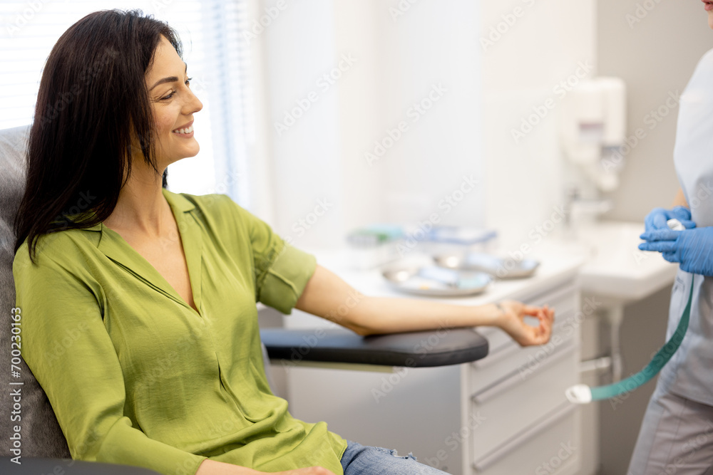 Exhausted woman is waiting for blood tests to be taken while sitting in the laboratory Exhausted woman is waiting for blood tests to be taken while sitting in the laboratory