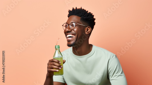 Joyful man holding a bottle.