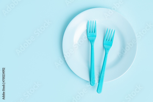 Food concept with children cutlery on blue background