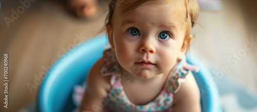 Close-up of adorable 12-month-old baby girl on a potty.