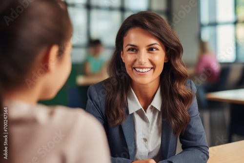 Portrait of smiling beautiful teacher in a class at elementary school looking at camera with learning students on background, ultra realistic photography, photorealistic, 32K, UHD, 