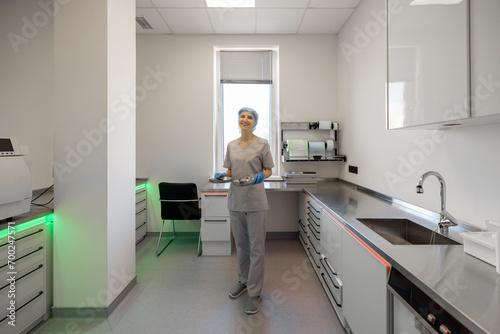 Medical worker works in the sterilization room of the operating room photo