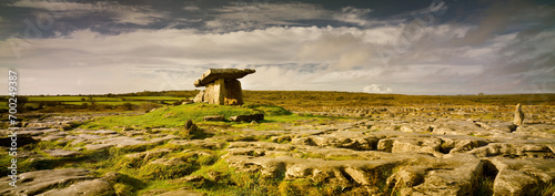 Poulnabrone Dolmen in Burren, county Clare, Ireland. Exposed karst limestone bedrock at the Burren National Park. Neolithic age capstone portal with spectacular landscape. High resolution panorama.