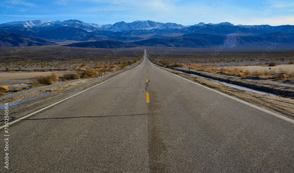 Straight Road in the California desert, going into the mountains near Death Valley National Park Straight Road in the California desert, going into the mountains near Death Valley National Park