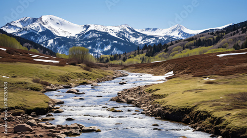 A mountain landscape in spring with snow melting and rivers flowing. © Gabriel