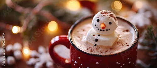 Hot chocolate served in a red mug with a marshmallow snowman.