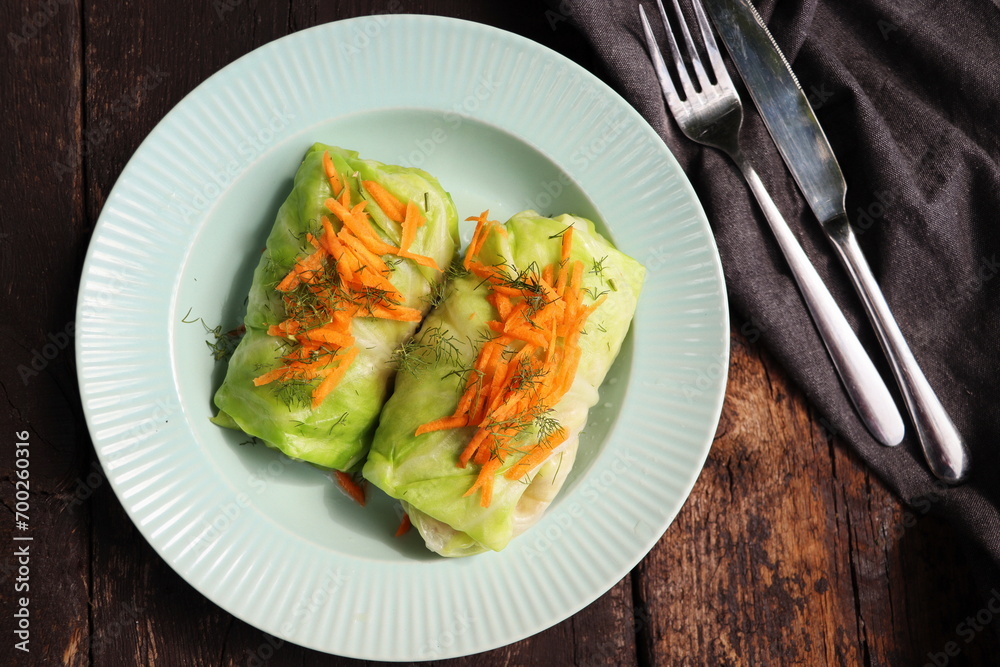 Cabbage rolls stuffed with meat on plate over green background. Top view, flat lay Cabbage rolls stuffed with meat on plate over green background. Top view, flat lay