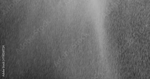 Rain Medium 5 3729 2K Diagonal heavy rain falling in front of the camera against black screen. Raindrops splashing. Rain closeup vfx insert. Practical seamlessly loopable footage. Heavy rainstorm hitt photo