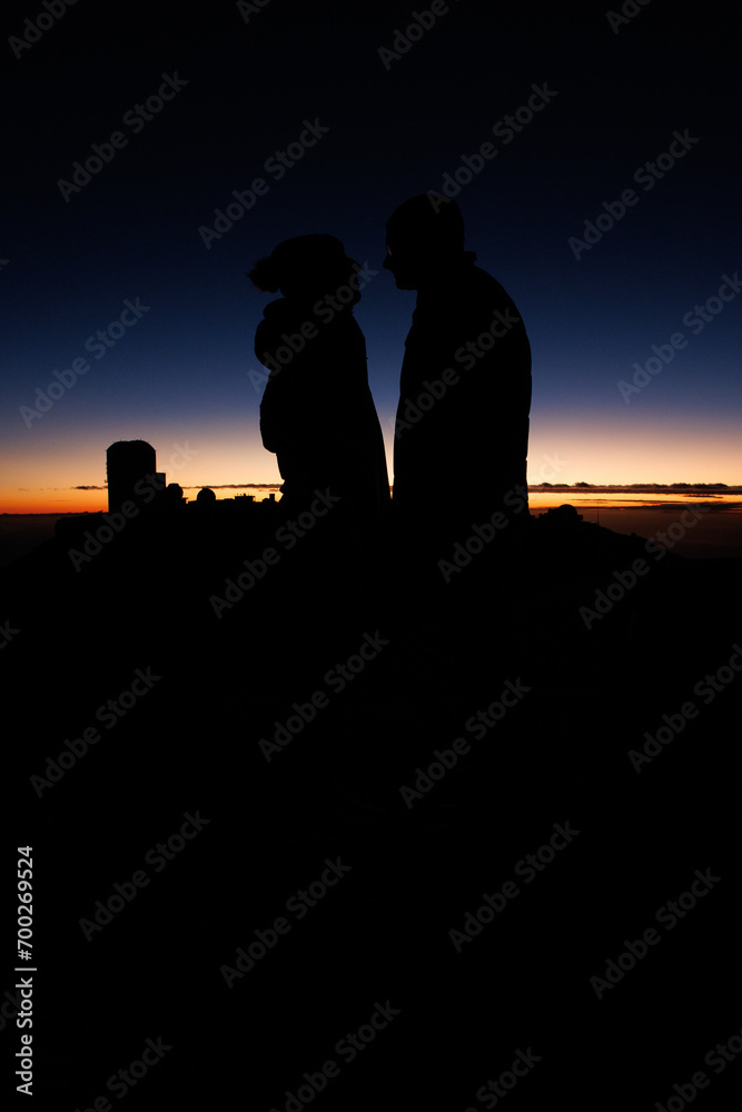 Silhouetted couple against a sunset