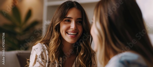 Indoor therapy session with female psychologist and smiling patient in close-up. photo