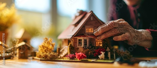 Elderly woman investing in a new house, exploring housing plans at home.
