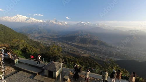 Time lapse of tourist visit Sarangkot viewpoint enjoy sunrise over village with Annapurna mountain range background Himalayas photo