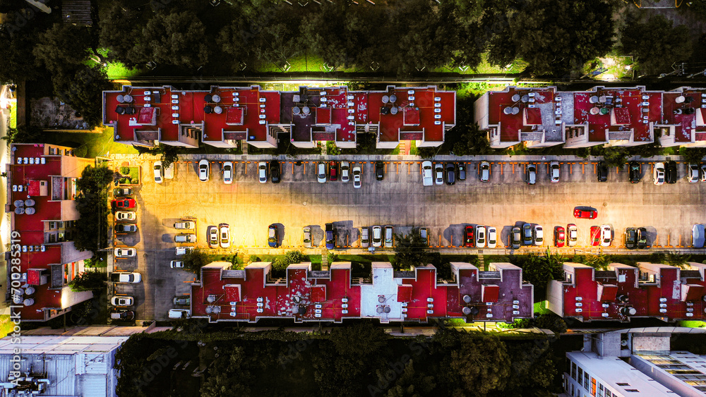 Topdown view of a condominium with parking lot at night Topdown view of a condominium with parking lot at night
