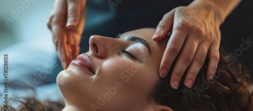 CST practitioner massaging woman's head.
