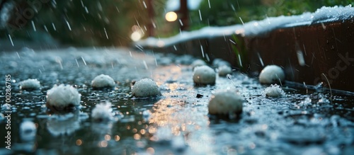 Hail balls under gutter in flooded garden after thunderstorm. photo