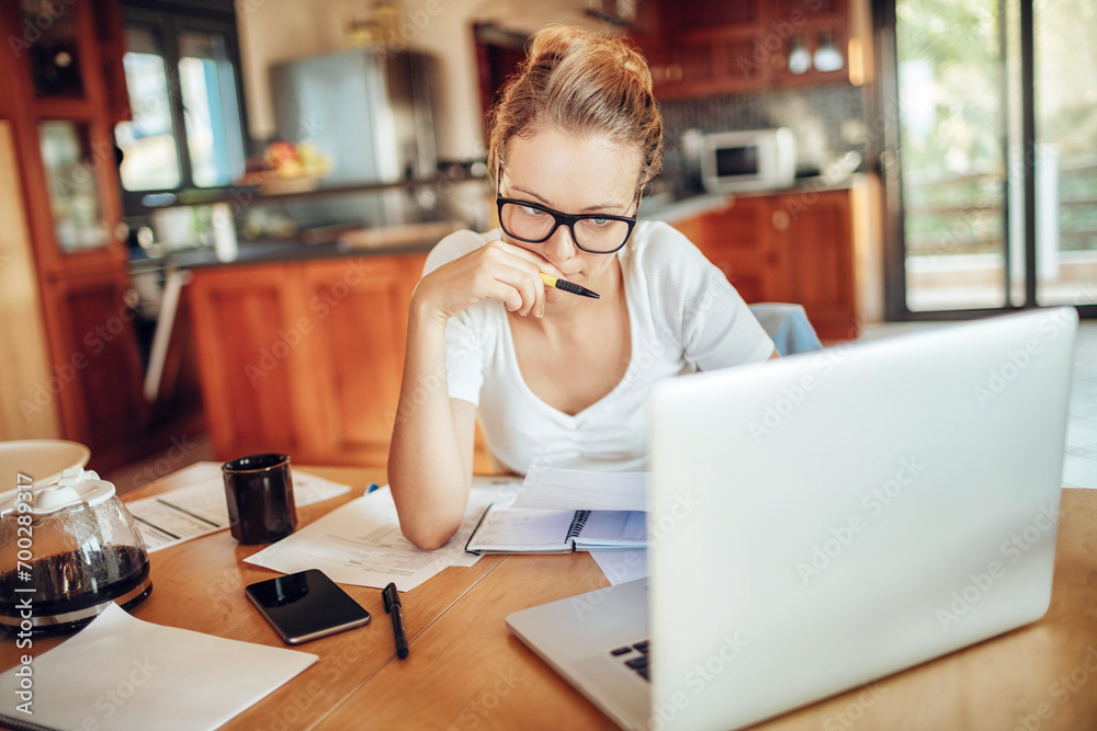 Focused Woman Working on Finances at Home Focused Woman Working on Finances at Home