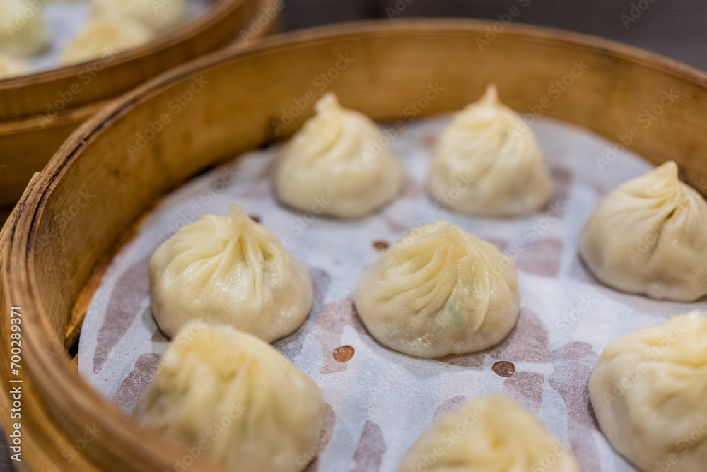 Steamed xiaolongbao served in a traditional steaming basket