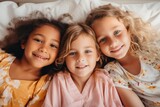 Group portrait of diverse little girls on the bed