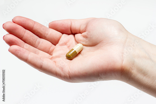 Medical tablet in hand on white background