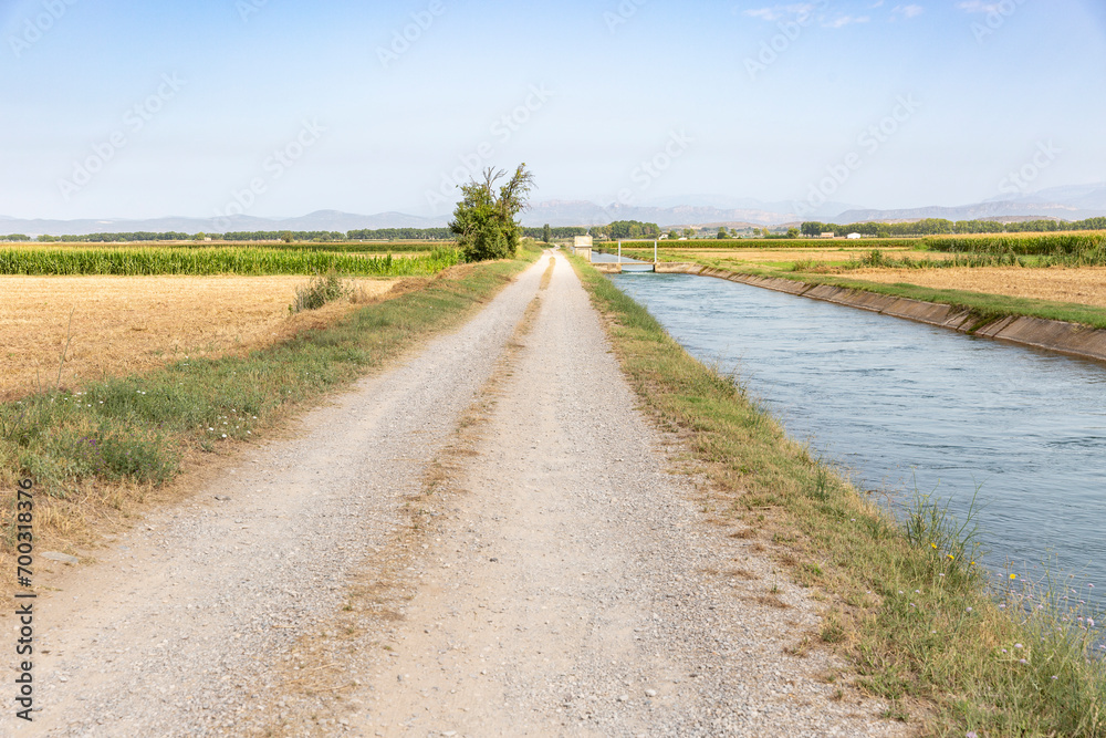auxiliary Canal d'Urgell through agricultural fields next to Linyola, comarca of Pla d'Urgell, Province of Lleida, Catalonia, Spain auxiliary Canal d'Urgell through agricultural fields next to Linyola, comarca of Pla d'Urgell, Province of Lleida, Catalonia, Spain