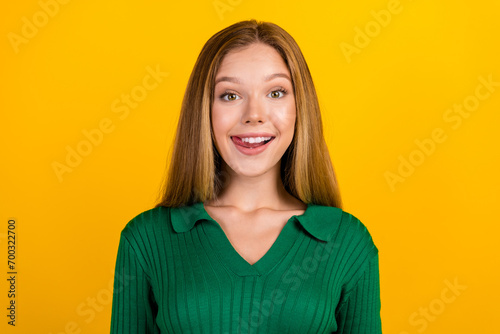 Photo of positive adorable person beaming smile tongue lick teeth isolated on yellow color background © deagreez
