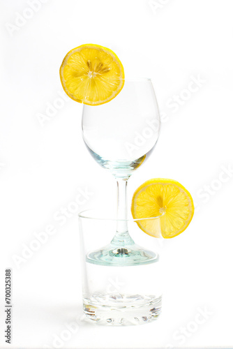 Glass with a transparent cocktail and lemon