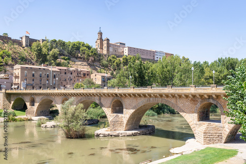 Sant Miquel old bridge over Segre river with a view to the Sant Crist in Balaguer, comarca of Noguera, Province of Lleida, Catalonia, Spain photo