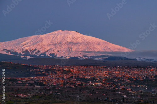 Obraz na płótnie Bronte town under the snowy and majestic volcano Etna and a cloudy blue sky w salonie