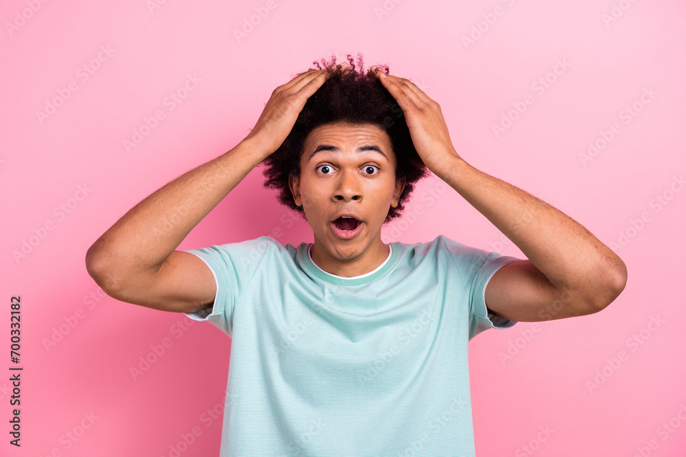 Photo portrait of attractive young man touch head terrible news shocked wear trendy blue clothes isolated on pink color background Photo portrait of attractive young man touch head terrible news shocked wear trendy blue clothes isolated on pink color background