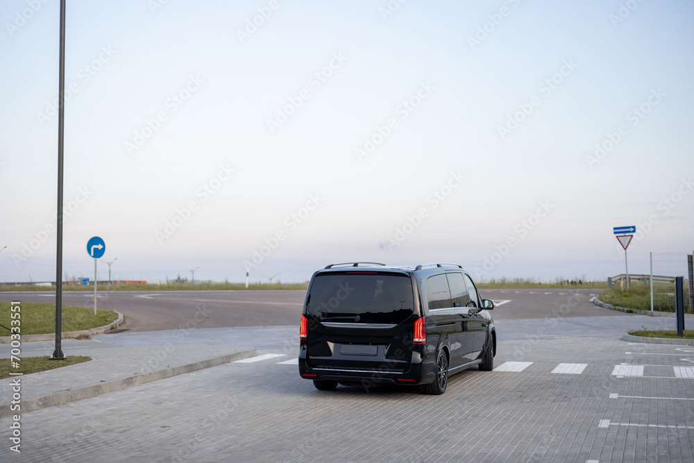Black luxury minivan taxi on parking lot outdoors