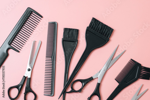 Set of hairdresser tools on a pink background. photo