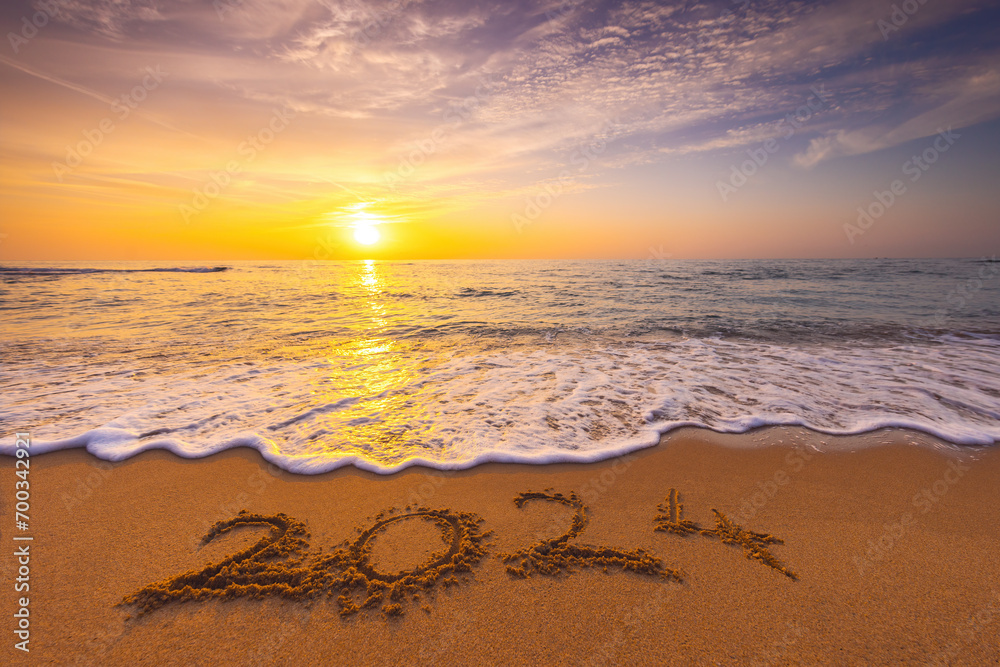 Happy New Year 2024 concept, lettering on the beach. Written text on the sea beach at sunrise. Happy New Year 2024 concept, lettering on the beach. Written text on the sea beach at sunrise.