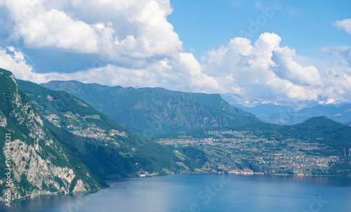 Mountain landscape, picturesque mountain lake in the summer morning, large panorama, landscape with fabulous lake view from the top of the mountain, with view of city. Iseo, Italy