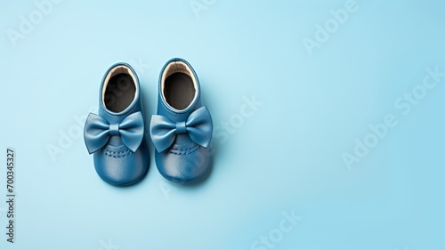 Gender neutral baby shoes and accessories over blue background