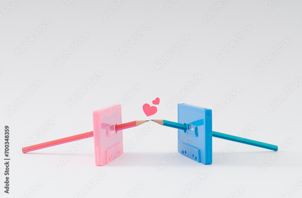 You're the pencil to my cassette tape. Old pink and blue audio cassette tapes and pencils kissing. Minimal love concept. Creative cassette tape idea. Retro love aesthetic background. Retro nostalgia. You're the pencil to my cassette tape. Old pink and blue audio cassette tapes and pencils kissing. Minimal love concept. Creative cassette tape idea. Retro love aesthetic background. Retro nostalgia.