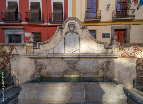 Granada, Spain; December-25, 2023: View of Plaza Nueva with the church of Santa Ana and the Pilar del Toro fountain, at the entrance to the Albaicin neighborhood in Granada (Spain) photo