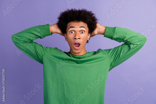 Photo of cheerful positive guy wear green pullover arms head open mouth isolated purple color background