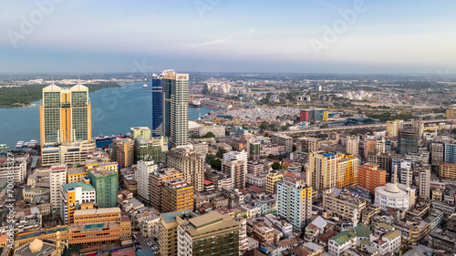 Cityscape of Dar es Salaam at sunset featuring residential and office buildings. © STORYTELLER