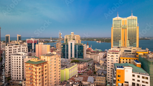 Cityscape of Dar es Salaam at sunset featuring residential and office buildings. photo