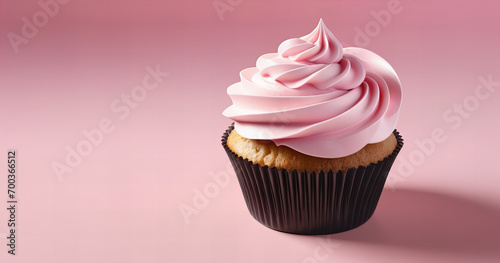 creamy and delicious cupcake with frosting on pink background