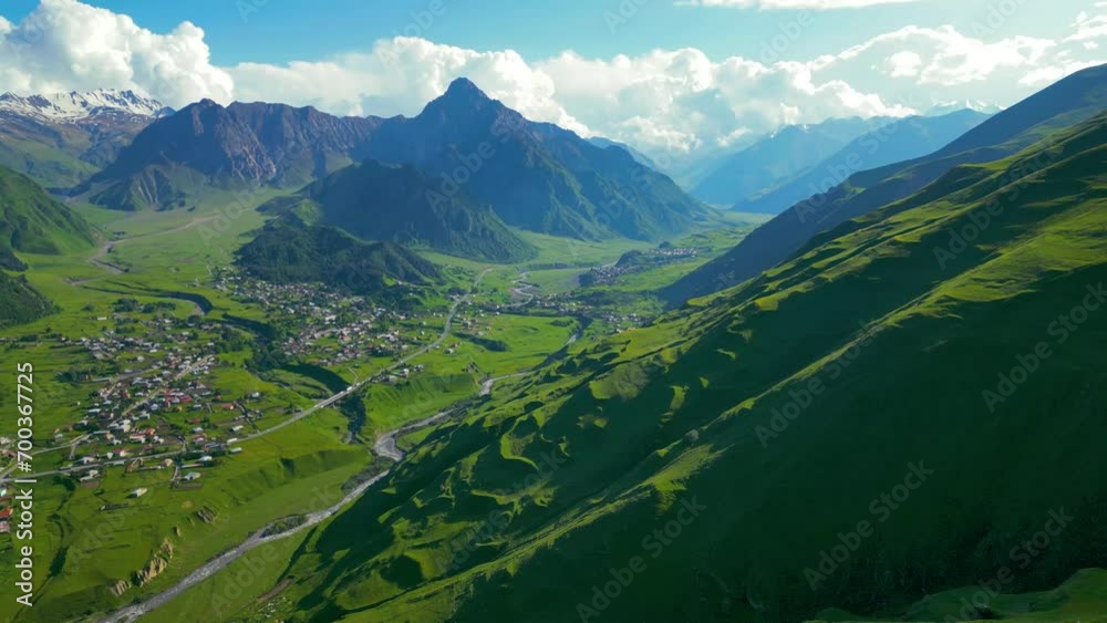 aerial video - a mountain peak stands above the green hills aerial video - a mountain peak stands above the green hills
