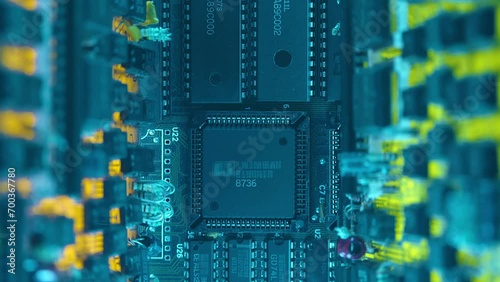 Electronic boards with many different microcircuits and other radio components show the complexity of the products of the modern electronics industry. Closeup. Macro. Shot in motion photo