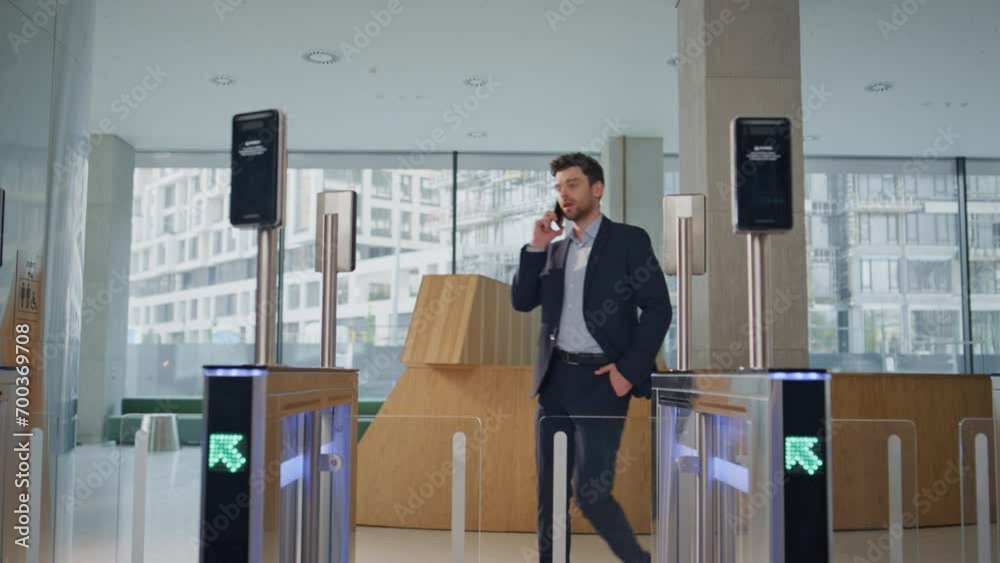 Calling man walking office electronic gates using face id. Guy passing turnstile Calling man walking office electronic gates using face id. Guy passing turnstile