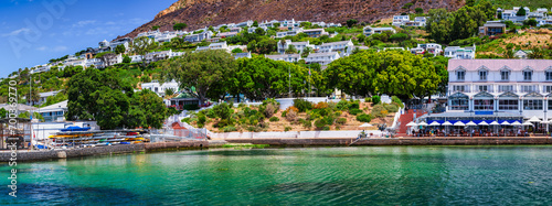 Panorama shot of Simon's Town Waterfront with turquoise water and town houses on the mountain slopes in the background, peninsula, Cape Town, South Africa photo