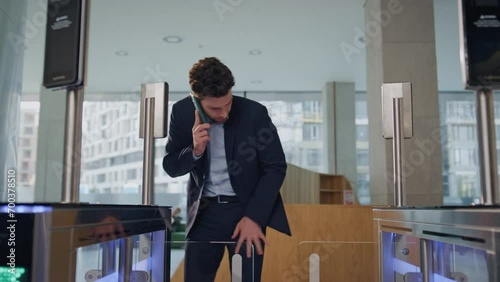 Man looking card turnstile hurrying to office work. Busy manager using keycard