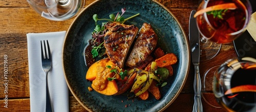 Barbecued crocodile tail fillet with sweet potato and spicy mango chutney on a plate viewed from the top.