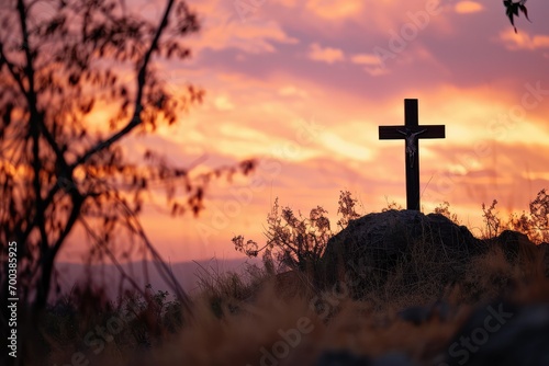 A rustic cross on a hill, the sky painted in shades of orange and pink, the scene a blend of natural beauty and spiritual symbolism.