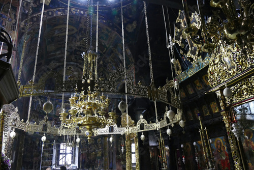 Chandelier with frescoes on walls and Iconostasis photo